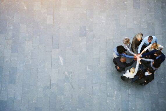 A team of accountants joining hands.